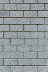 Light gray brick wall with rough, uneven texture. Repeating rect