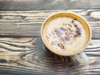 A fresh cup of coffee with cocoa granule as topping. The combination of strong coffee, creamy flavor, smooth foam, and crunchy choco granule.