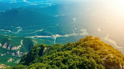 A mountain landscape reveals a vista of lush greenery rocky cliffs winding paths and distant hazy ridges under bright sunlight