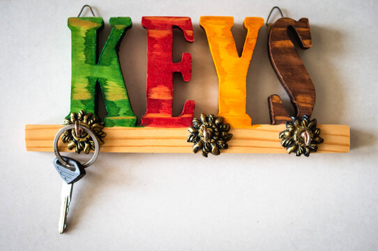 Key holder in front of white background with a key