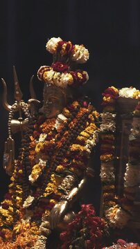 Varanasi, Uttar Pradesh, India. Ceremony Ganga Maha Aarti. Brahman Brahman priest wearing red and yellow dress doing traditional ganga aarti at ghat, Varanasi, Uttar Pradesh, India Puja ritual in