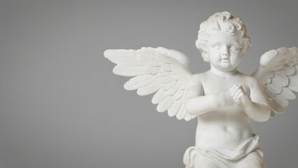 Fototapeta premium White angel statue with wings and a face