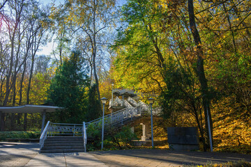 Metal staircase leading to the grave of Ukrainian poet Taras Shevchenko on Chernecha Hill in Kaniv, Ukraine, surrounded by colorful autumn foliage
