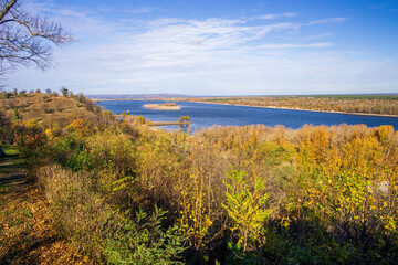 Scenic autumn landscape showing the Dnieper river flowing near the Taras Shevchenko Grave, located on Chernecha Hill in Kaniv, Ukraine, under a beautiful blue sky