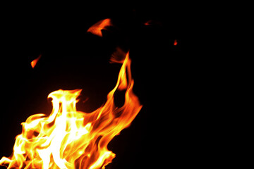 Close up burning flames on black background for graphic design or wallpaper.