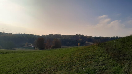 Obraz premium Green fields, hills and meadows. Landscape of Kashubia in autumn.