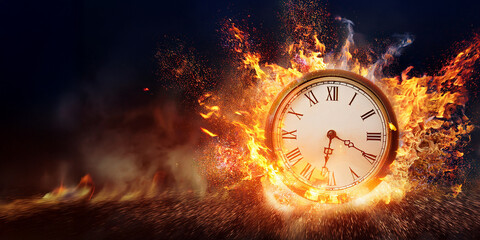Burning clock on fire with dark background