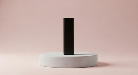 Black rectangular prism on a round platform against a pink background.