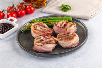 Tasty grilled pork medallion with bacon