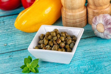 Pickled canned capers in the bowl