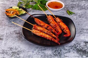 Grilled prawn skewer served sauce