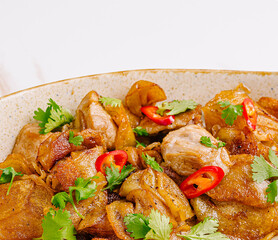 Deliciously cooked chicken with crispy potatoes and herbs in culinary setting