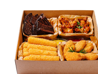Delicious platter of crispy snacks featuring wings, cheese sticks, and bread