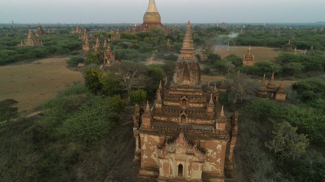 Aerial view of ancient temples pierce the tranquil landscape, their weathered facades standing as silent witnesses to centuries of history, Old Bagan, Mandalay Region, Myanmar.