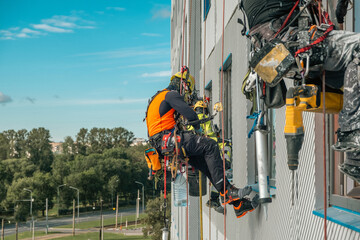 Rope access specialists on the facade of a building
