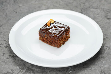 chocolate cake dessert in a white plate on a gray background