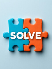 Obraz premium Two puzzle pieces, blue and orange, with 'solve' text.