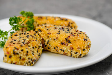 vegetarian cutlets in a white plate on a gray background macro photo