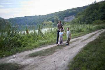Fototapeta premium Woman and children hiking