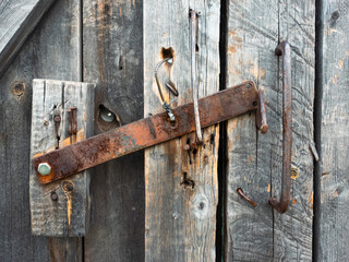 old fashioned padlock on a wooden door	
