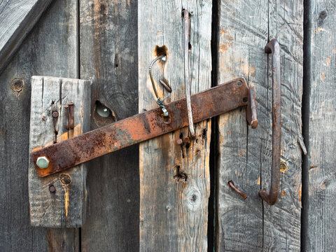 old fashioned padlock on a wooden door	
