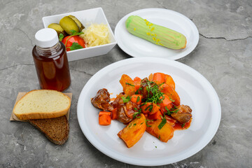 set of potatoes with meat and salad and dessert on a background with bread and drink
