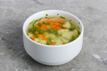 cauliflower soup in a white plate macro