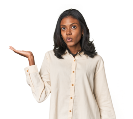 Portrait of a young Indian woman impressed holding copy space on palm.