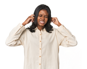 Portrait of a young Indian woman covering ears with hands.