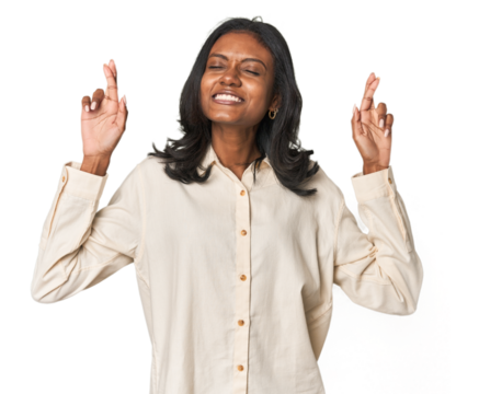 Portrait of a young Indian woman crossing fingers for having luck - Powered by Adobe