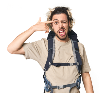 Young Caucasian hiker with backpack showing a disappointment gesture with forefinger.