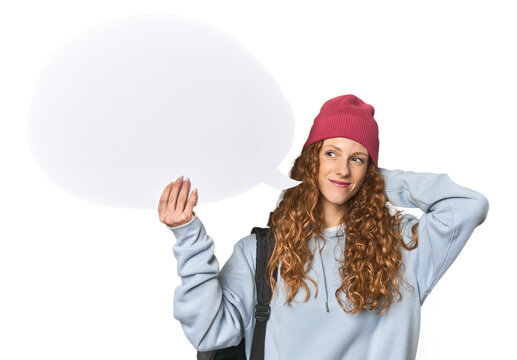 Redhead holding a comic speech bubble touching back of head, thinking and making a choice.