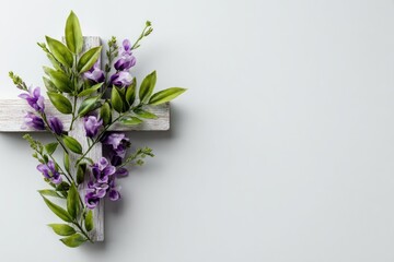 White wooden cross adorned with purple flowers and greenery (1)