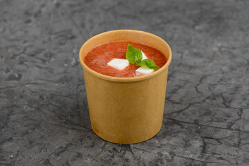 tomato cream soup in a disposable container