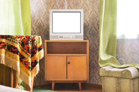 An old TV with a white screen on the bedside table against the background of wallpaper. - Powered by Adobe