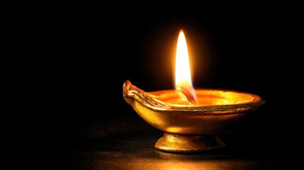 Warm glow of a diya flame, symbolizing spiritual ritual and cultural celebration.
