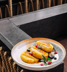 Delicious pancakes served with fresh berries in modern dining setting