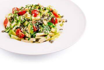 Fresh green salad with tomatoes and pumpkin seeds served in a bowl