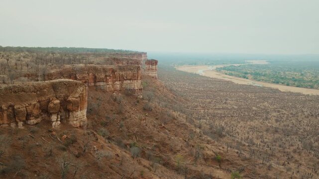 Aerial drone footage of the iconic Chilojo Cliffs in Gonarezhou National Park, Zimbabwe. Dramatic sandstone escarpment rising above the savanna part 4