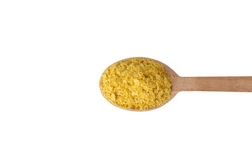 Savoury vegan yeast flakes on wooden spoon isolated on white background.