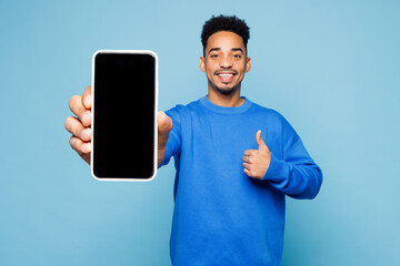 Young man of African American ethnicity wear sweatshirt casual clothes hold in hand use close up...