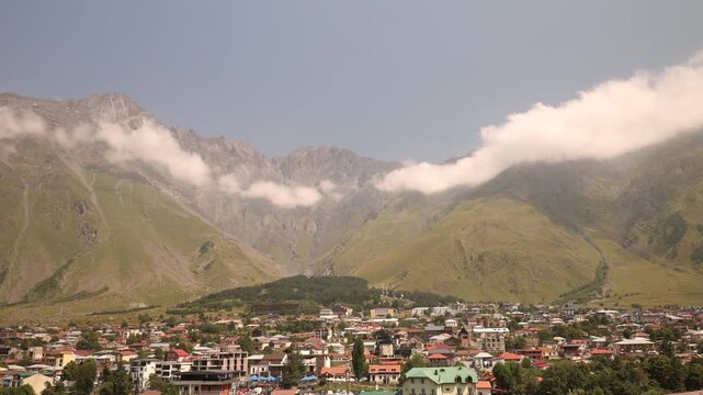 picturesque Village in mountainous valley with rolloing cloudscape over mountain peaks, north Georgia.