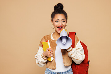 Young girl student wear casual clothes backpack bag hold books scream in megaphone scream announces discounts sale Hurry up isolated on plain beige background. High school university college concept.