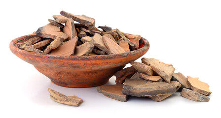 Clay bowl filled with ceramic shards isolated on white background