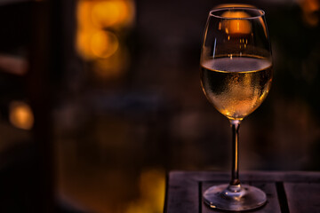 a glass of cold white wine and serving in the restaurant