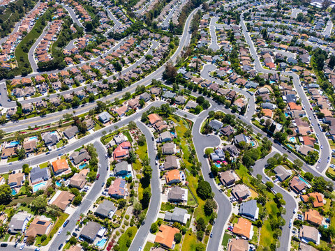 Drone view of  suburban block with swimming pools and landscaped lots