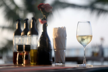glass of cold white wine on the summer seashore by the water, relaxing by the water, a gentle background of soft color