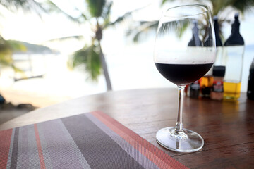 dinner in a restaurant with wine, beautiful table setting, a glass of wine in the foreground