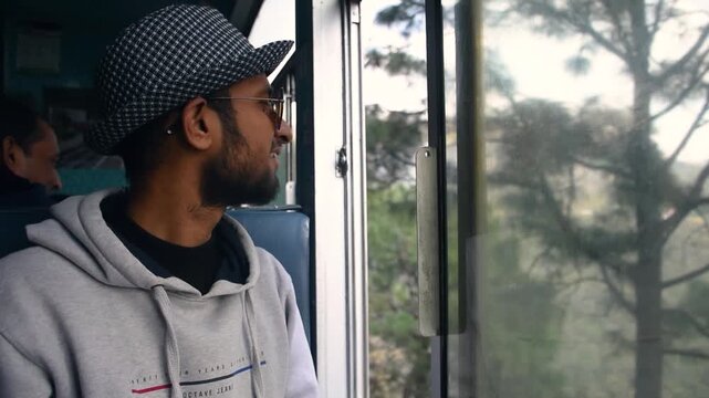 A man enjoys a ride on the toy train running from Kalka to Shimla (Simla), the capital of Himachal Pradesh in North India, located in the northern Himalayas. It is part of the Indian Mountain Railways