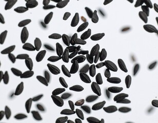 Close-up of black cumin seeds floating mid-air above a neutral-toned